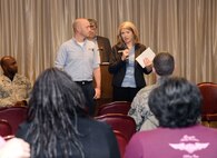 Mike Green, left, facility manager, and Ashleigh Talk, community manager for Balfour Beatty Communities, talk about the company's continued improvement of quality of service and professionalism of vendors and staff during the Tinker Town Hall Jan. 26 at the Tinker Club.