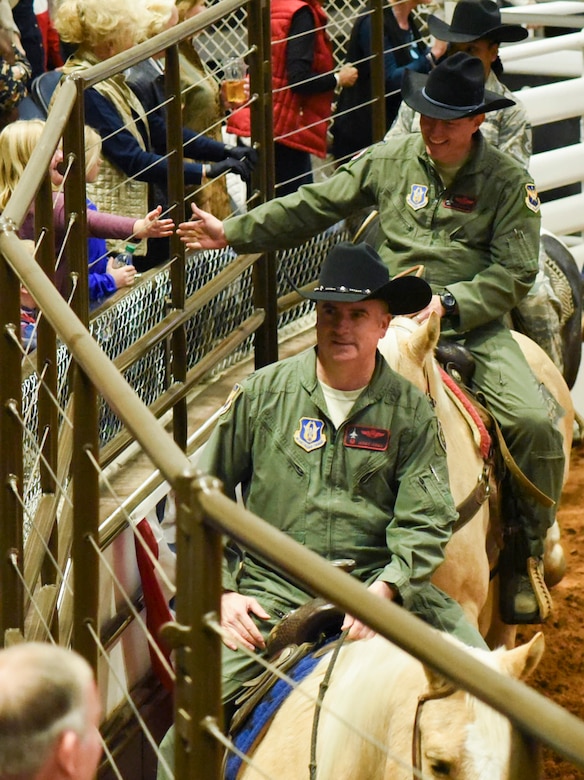 Col. Gregory Jones, 301st Fighter Wing commander, and Col. Mitch Hanson, 301 FW vice commander, ride in the Fort Worth Stock Show and Rodeo's Grand Entry during Military Appreciation Day at Will Rogers Coliseum in Fort Worth, Texas, January 29, 2018. As this rodeo celebrates their centennial year as the world's first-ever indoor rodeo, the Air Force Reserve will celebrate their 70th birthday on April 14, 2018. (U.S. Air Force photo by Ms. Julie Briden-Garcia)