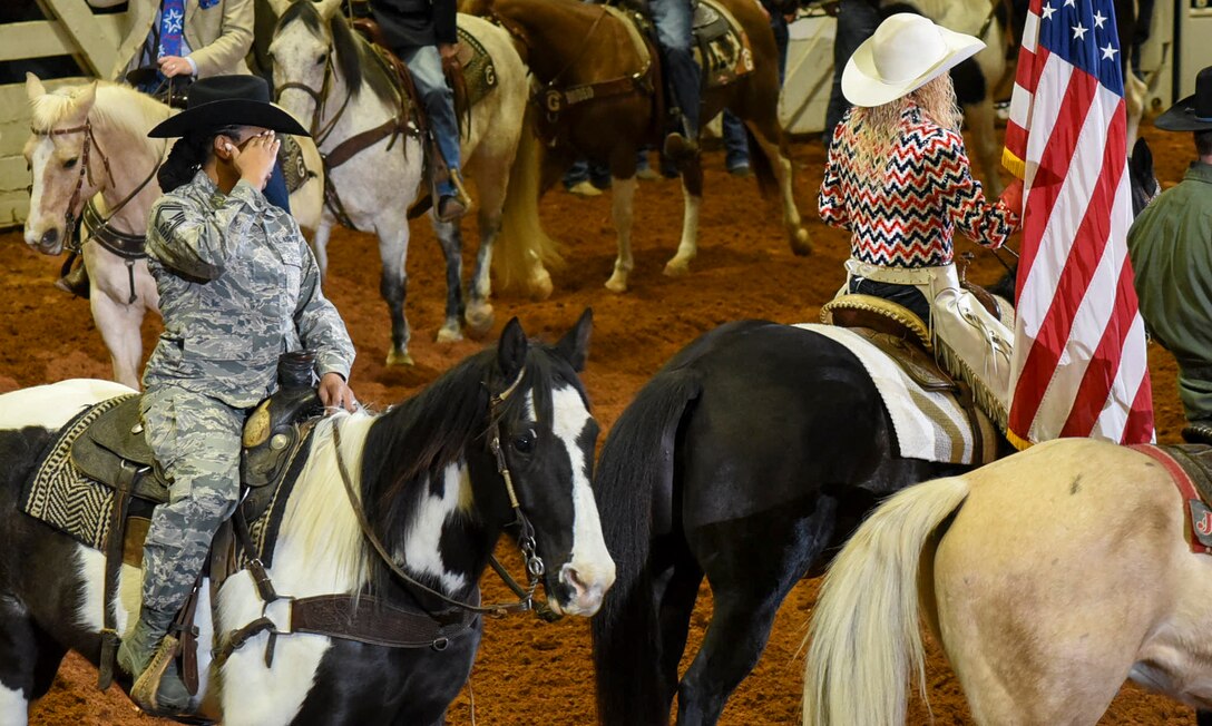 Senior Master Sgt. Natalie Hunter, 301st Logistics Readiness Squadron’s logistics supply manager, salutes the American flag during the Fort Worth Stock Show and Rodeo's Grand Entry on Military Appreciation Day at Will Rogers Coliseum in Fort Worth, Texas, January 29, 2018. As this rodeo celebrates their centennial year as the world's first-ever indoor rodeo, the Air Force Reserve will celebrate their 70th birthday on April 14, 2018. (U.S. Air Force photo by Ms. Julie Briden-Garcia)