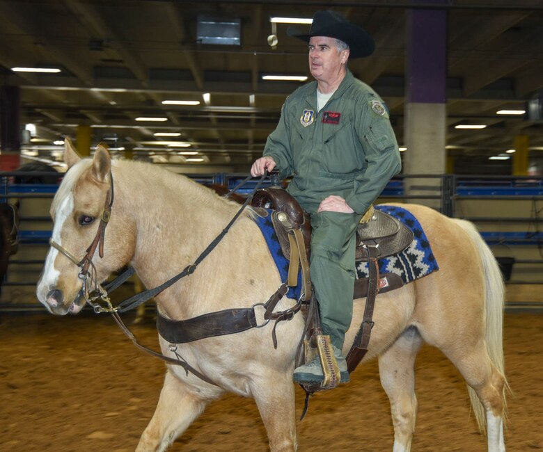 Col. Gregory Jones, 301st Fighter Wing commander, warms up his horse before riding in the Fort Worth Stock Show and Rodeo Grand Entry during Military Appreciation Day at Will Rogers Coliseum in Fort Worth, Texas, on January 29, 2018. As this rodeo celebrates their centennial year as the world's first-ever indoor rodeo, the Air Force Reserve will celebrate their 70th birthday on April 14, 2018. (U.S. Air Force photo by Ms. Julie Briden-Garcia)