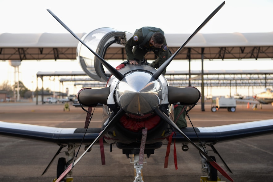 Capt. Hunter Barnhill, a 37th Flying Training Squadron instructor pilot, pulls himself out of a T-6A Texan II Jan. 26, 2018, on Columbus Air Force Base, Mississippi. He was diagnosed with brain cancer in 2017, but has remained optimistic by staying strong spiritually. (U.S. Air Force photo by Airman 1st Class Keith Holcomb)