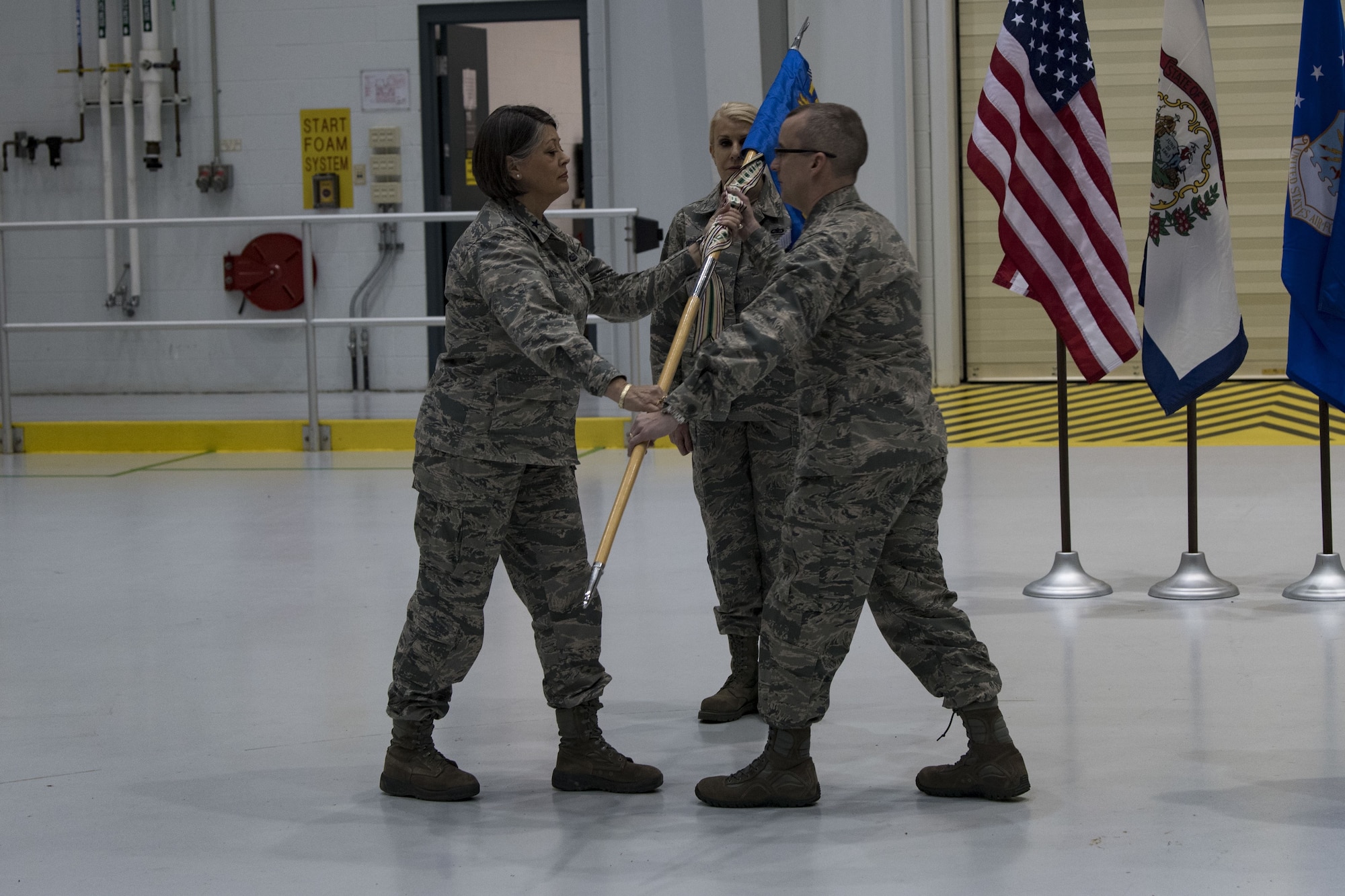 U.S. Air Force Brig. Gen. Paige Hunter (left), the West Virginia National Guard Assistant Adjutant General - Air, gives command of the 130th Maintenance Group to U.S. Air Force Col. Patrick Chard at the 130th MXG change of command Feb. 1, 2018 at McLaughlin Air National Guard Base, Charleston, W.Va.Chard is assuming the command of the 130th MXG after being the Director of Staff at Headquarters West Virginia Air National Guard.(U.S. Air National Guard Photo by Airman 1st Class Caleb Vance)