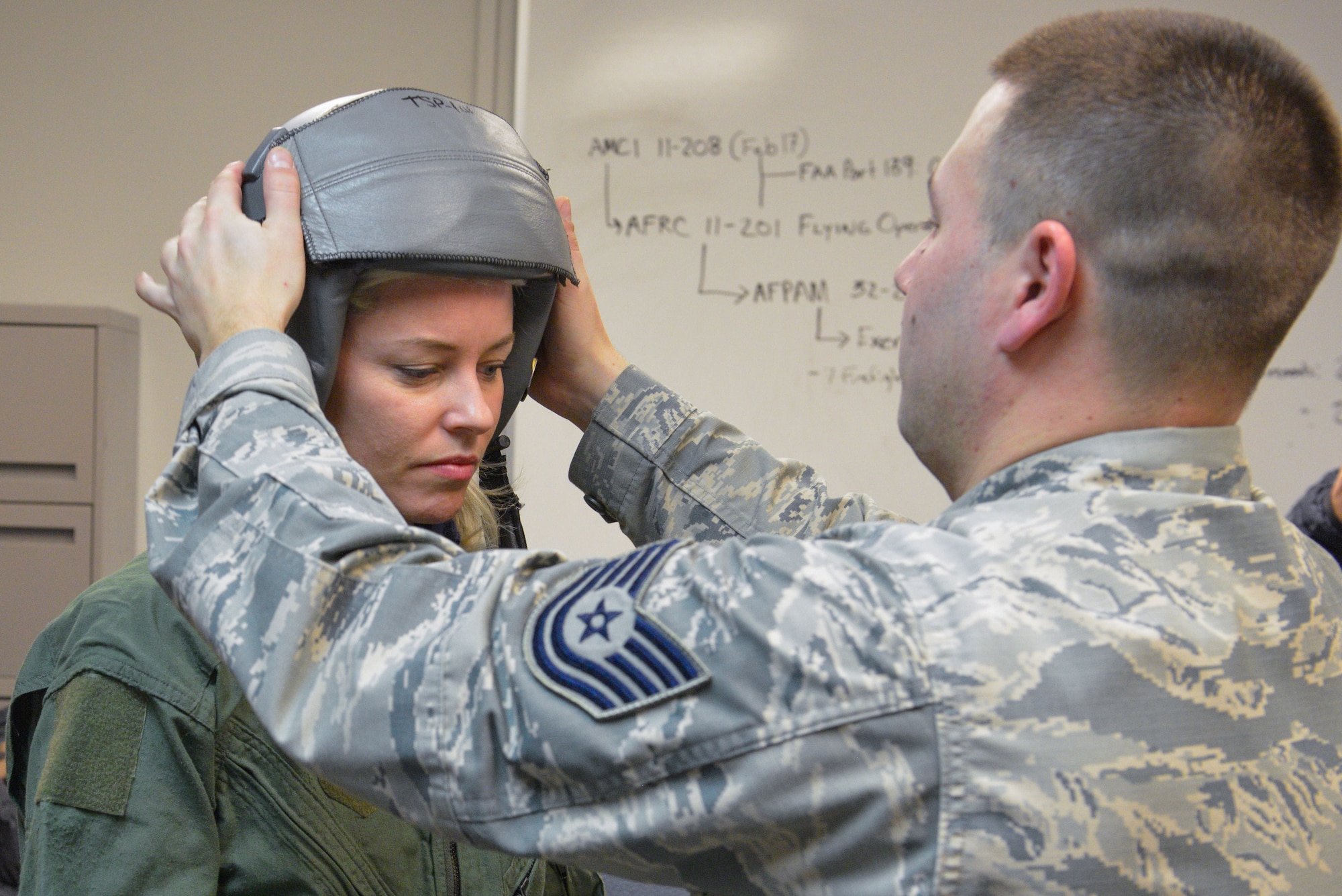 Tech Sgt. Brandon Blankensop, an Aircrew Flight Equipment Lead Trainer from the 20th Operations Support Squadron at Shaw AFB, S.C., helps fit actress Elizabeth Banks with a helmet prior to her flight on an F-16 Fighting Falcon at the Minneapolis-St. Paul Air Reserve Station, Minn., Feb 3, 2018.  Banks' flight was one of many offered this week by the Viper Demo team prior to their fly-over for Super Bowl LII. (U.S. Air Force photo by Master Sgt. Eric Amidon)