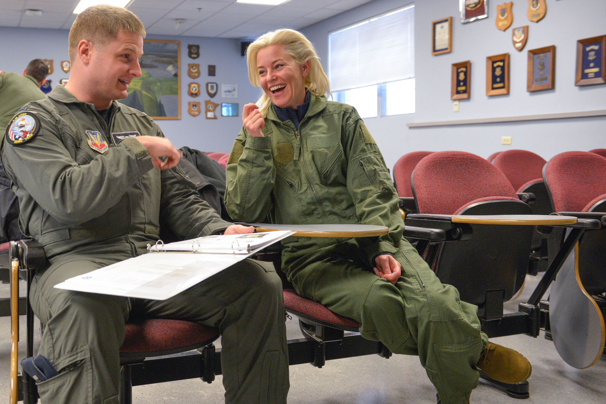 Actress Elizabeth Banks shares a light-hearted moment with Cpt. Brian Leber of the Viper Demo Team, as he discusses proper operation of the ejection system prior to her flight in an F-16 Fighting Falcon at the Minneapolis-St. Paul Air Reserve Station, Minn., Feb 3, 2018. The team is in town to participate in the Air Force Heritage Flight fly-over for Super Bowl LII. (U.S. Air Force photo by Master Sgt. Eric Amidon)