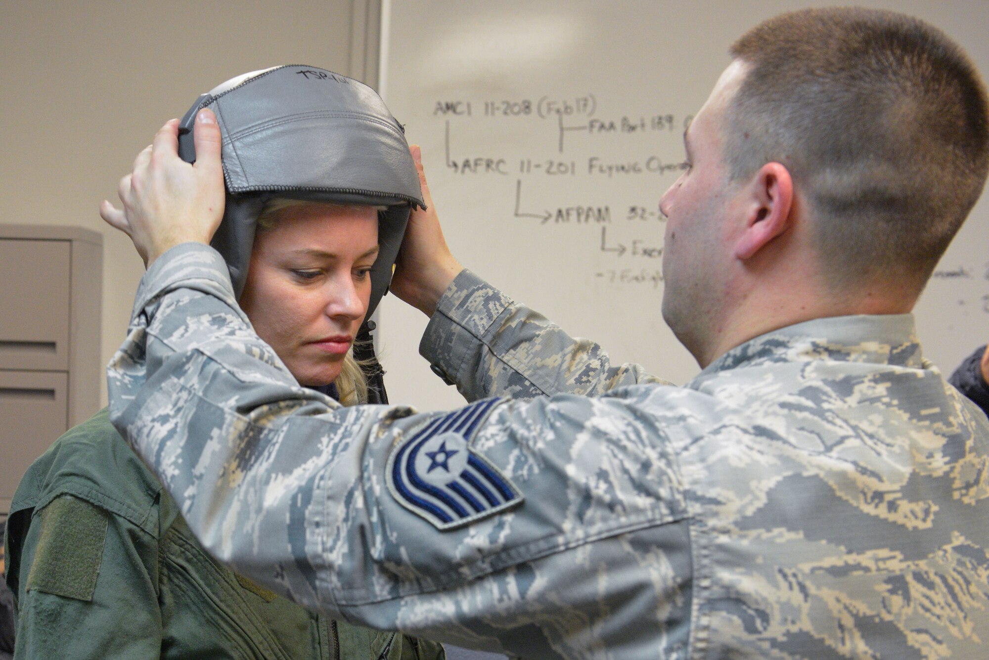 Tech Sgt. Brandon Blankensop, an Aircrew Flight Equipment Lead Trainer from the 20th Operations Support Squadron at Shaw Air Force Base, S.C., helps fit actress Elizabeth Banks with a helmet prior to her flight on an F-16 Fighting Falcon at the Minneapolis-St. Paul Air Reserve Station, Minn., Feb. 3, 2018. Banks' flight was one of many offered this week by the Viper Demo team prior to their fly-over for Super Bowl LII. (U.S. Air Force photo by Master Sgt. Eric Amidon)