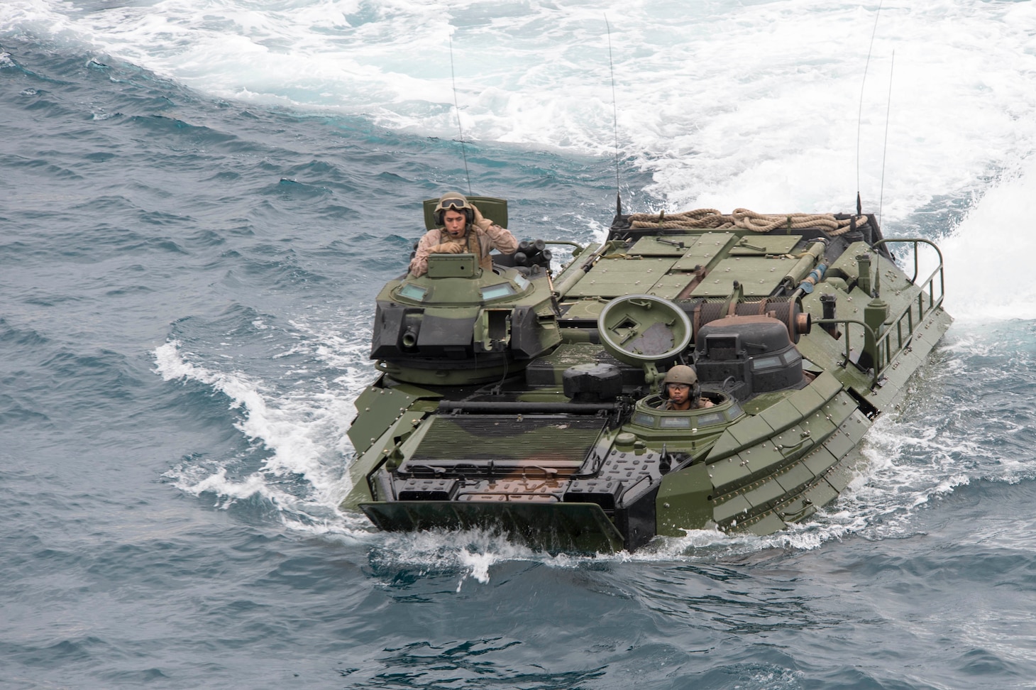 180202-N-DC385-389 WHITE BEACH, Okinawa (Feb. 2, 2018) Amphibious assault vehicles (AAV), attached to the 3d Marine Division (MARDIV), approach the well deck of the amphibious assault ship USS Bonhomme Richard (LHD 6).