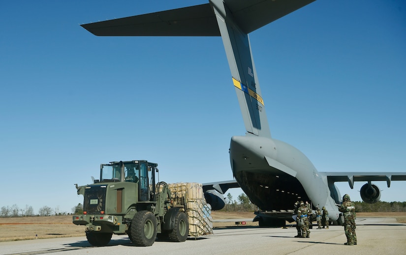 U.S. Air Force Airmen of the 321st Contingency Response Squadron, 621st Contingency Response Wing, Joint Base McGuire-Dix-Lakehurst, New Jersey, load cargo onto a C-17 assigned to the 437th Airlift Wing as part of Exercise Crescent Moon Jan. 30, at Joint Base Charleston’s North Auxiliary Airfield near Orangeburg, South Carolina.