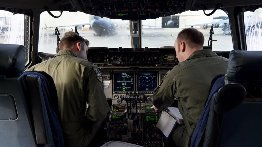 U.S. Air Force Capt. Alexander Congram, left, 14th Airlift Squadron pilot, and Royal Air Force Flight Leader Matt Jenkinson, right, 14th AS pilot apart of a foreign exchange pilot program, prepare for takeoff at Joint Base Charleston, S.C. Jan. 30, 2018.