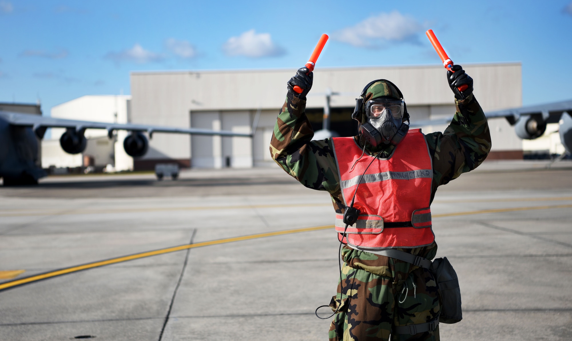 A U.S. Air Force Airman, 14th Airlift Squadron crew chief, marshals out a C-17 Globemaster III assigned to the 437th Airlift Wing in support of Exercise Crescent Moon at Joint Base Charleston, South Carolina. Jan. 30, 2018.