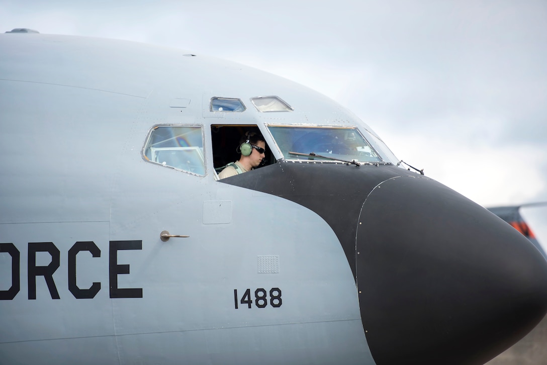 An airman sits in the cockpit of a KC-135R Stratotanker.