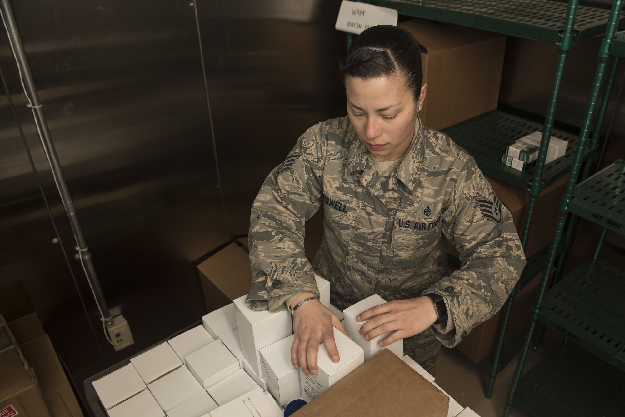 U.S. Air Force Staff Sgt. Melanie Bedwell, 20th Medical Support Squadron storage and distribution noncommissioned officer in charge, stacks pharmacy supplies onto a cart at the Shaw Air Force Base, S.C., Jan. 31, 2018.