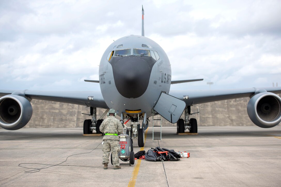 An airman stands in front of a KC-135R Stratotanker.
