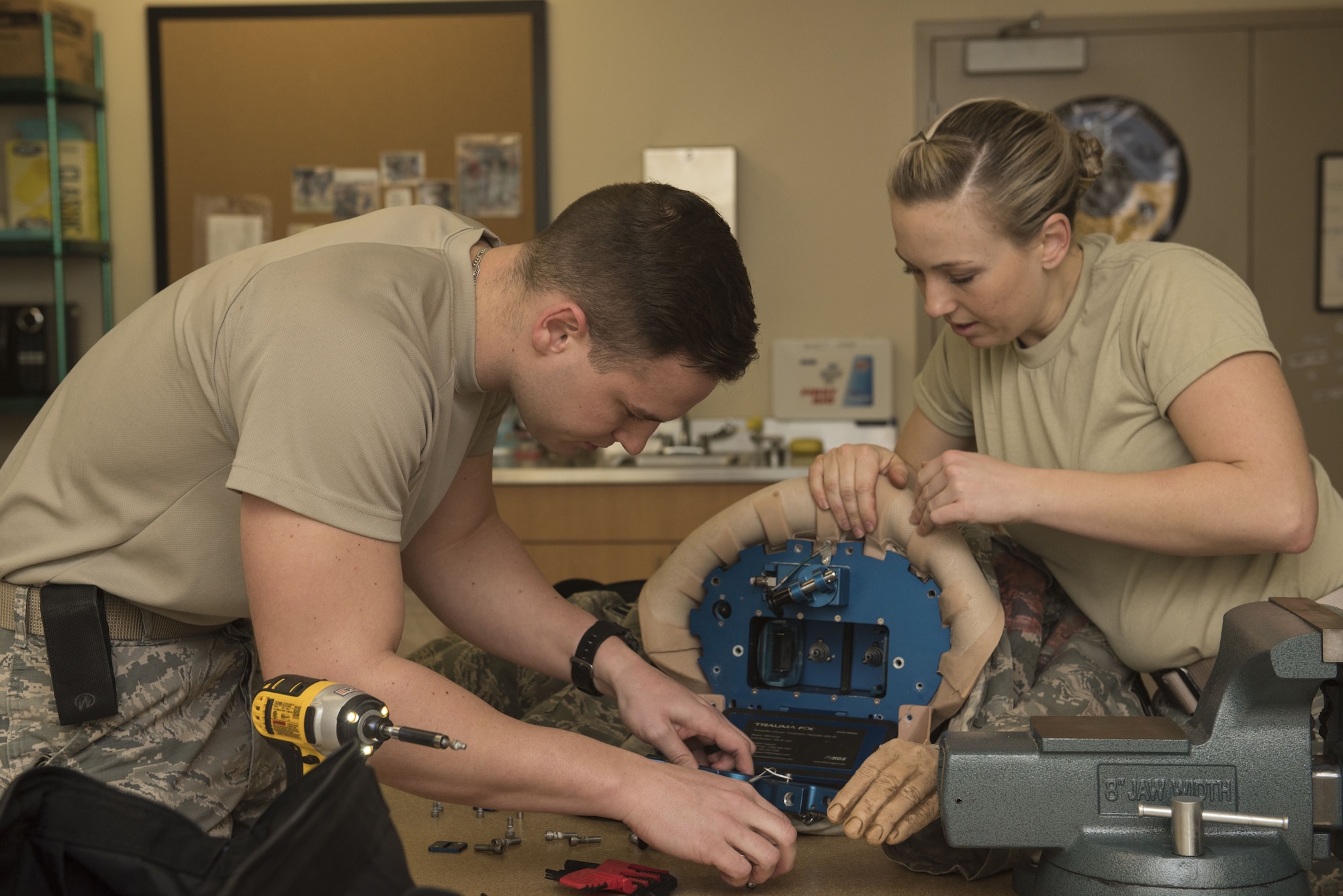 U.S. Air Force Airmen 1st Class Cody Knoll, left, and Jennifer Lesley, 20th Medical Support Squadron biomedical equipment technicians, take apart a trauma dummy prior to accomplishing a repair at Shaw Air Force Base, S.C., Jan. 31, 2018.
