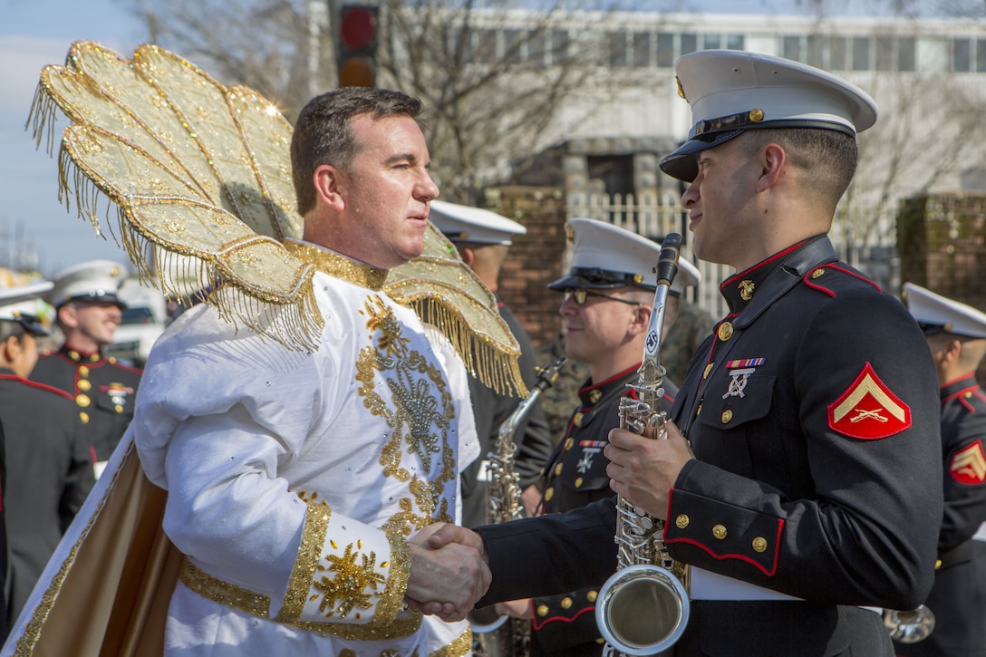 Jeffrey P. Wilke (left), the 86th King of Alla, and Lance Cpl. Montana Olle (right), a saxophone player with Marine Corps Band New Orleans, shake hands prior to the Krewe of Alla Mardi Gras parade, New Orleans, Feb. 4, 2018. Marine Corps Band New Orleans performs in multiple Mardi Gras parades annually to celebrate the Mardi Gras season and to show Marine Corps presence in the New Orleans Community.