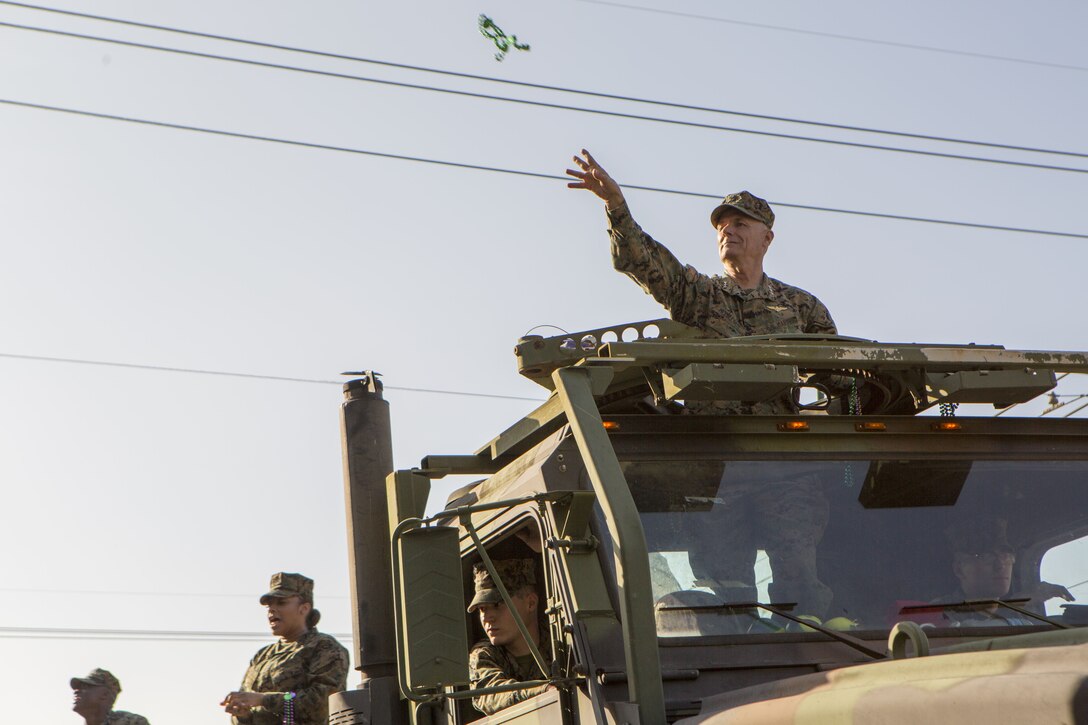 Lt. Gen. Rex C. McMillian (right), commander of Marine Forces Reserve and Marine Forces North, and other Marines with Marine Support Facility New Orleans, toss beads to New Orleans residents during the Krewe of Alla Mardi Gras parade,  New Orleans, Feb. 4, 2018. McMillian, along with key leaders from MARFORRES, took part in the parade to show support of the New Orleans community during the Mardi Gras season.