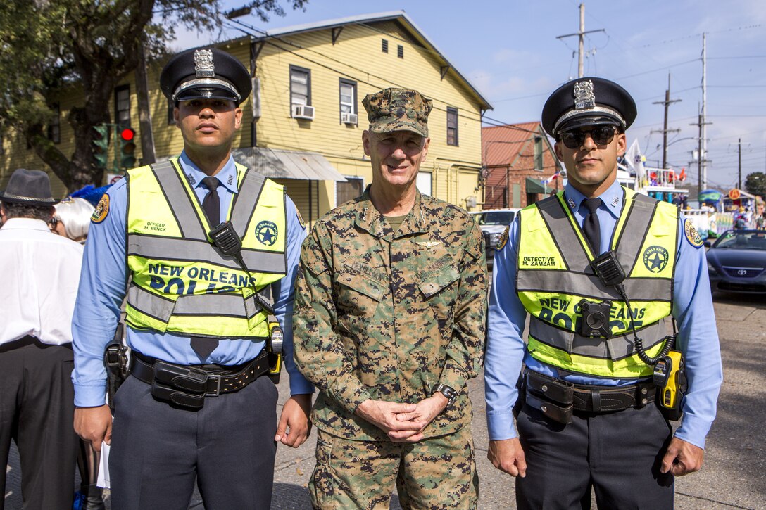 Lt. Gen. Rex C. McMillian, commander of Marine Forces Reserve and Marine Forces North, poses with police officers from the New Orleans Police Department before the Krewe of Alla Mardi Gras parade, New Orleans, Feb. 4, 2018. McMillian, along with key leaders from MARFORRES, headquartered in New Orleans, took part in the parade to celebrate the Mardi Gras season with the New Orleans community.