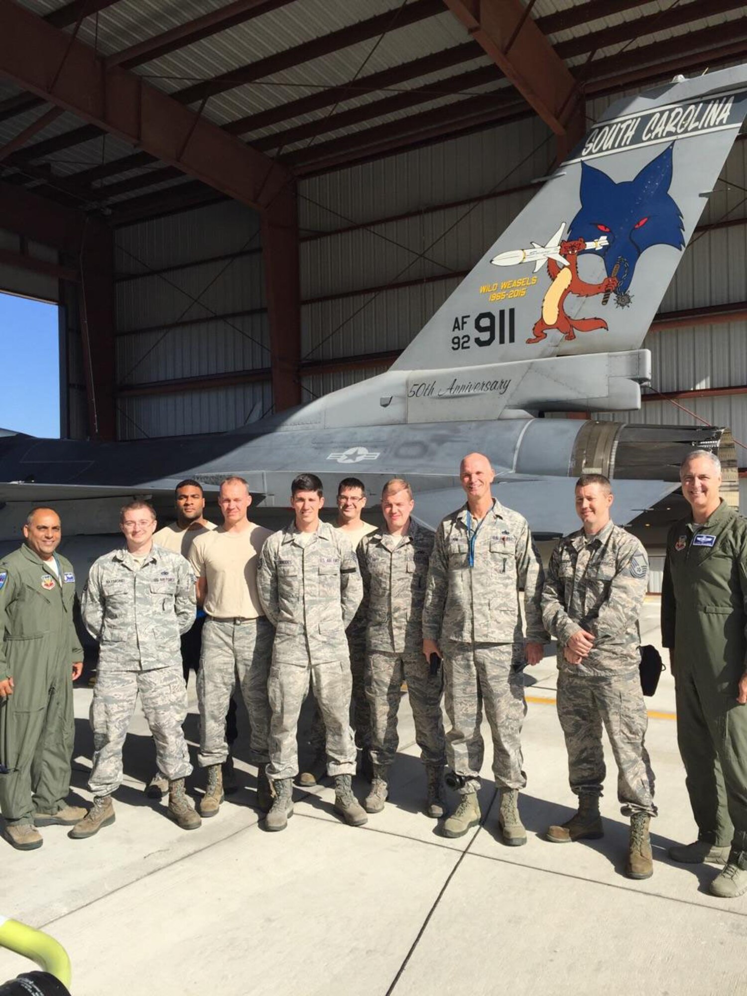 Col. Abu Gahndi, 169th Fighter Wing Commander and Lt. Gen. R. Scott Williams, Continental U.S. NORAD Region – 1st Air Force (Air Forces Northern) Commander, flank an F-16 Viper maintenance crew during Williams’ visit to the unit Dec. 5.  Williams regularly visits Air National Guard units throughout the country to stay current about operational issues and unit concerns. (Air Force photo by Capt. Emily Meredith)