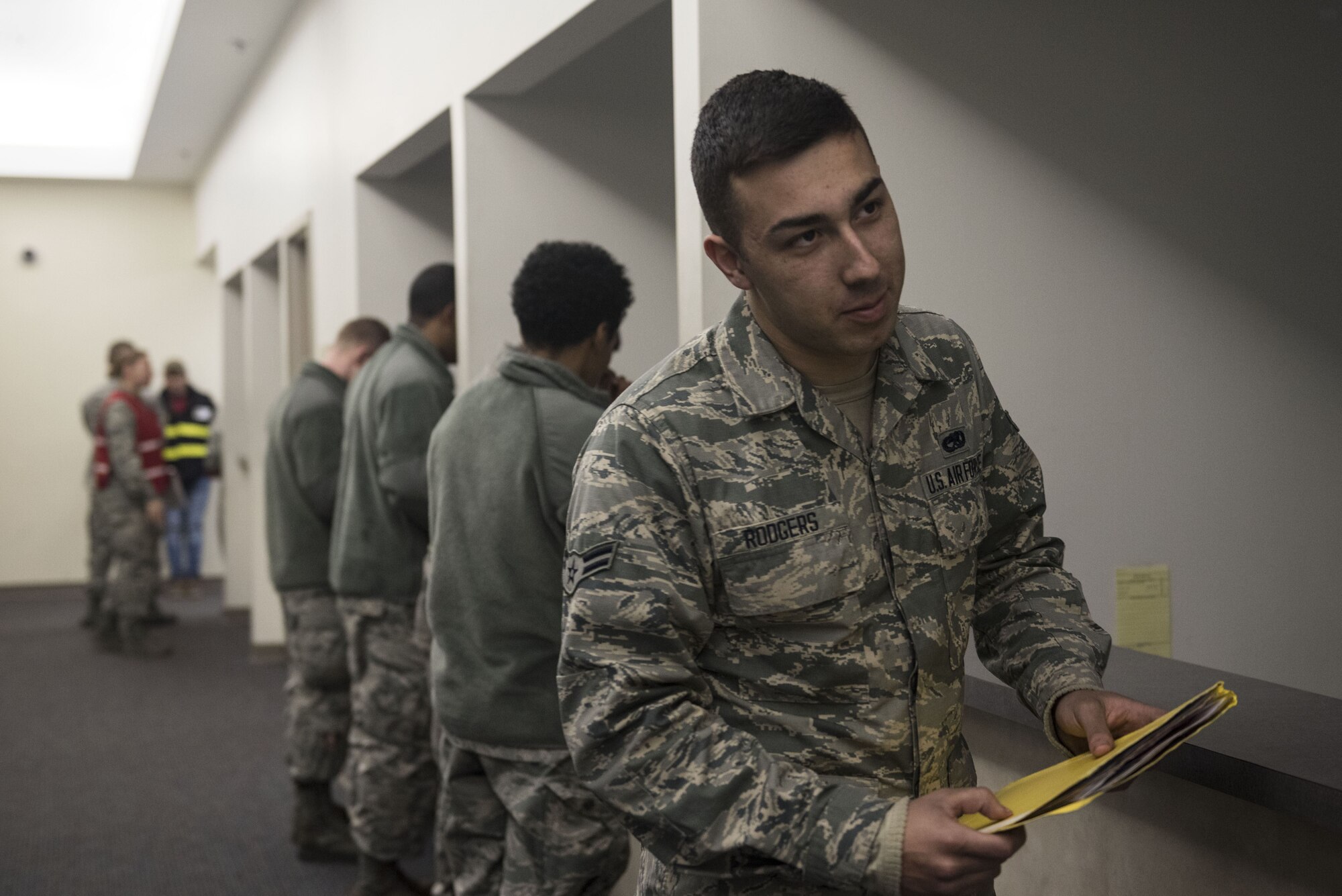 U.S. Airmen process through a pre-deployment line during a Phase I exercise at Shaw Air Force Base, S.C., Feb. 4, 2018.