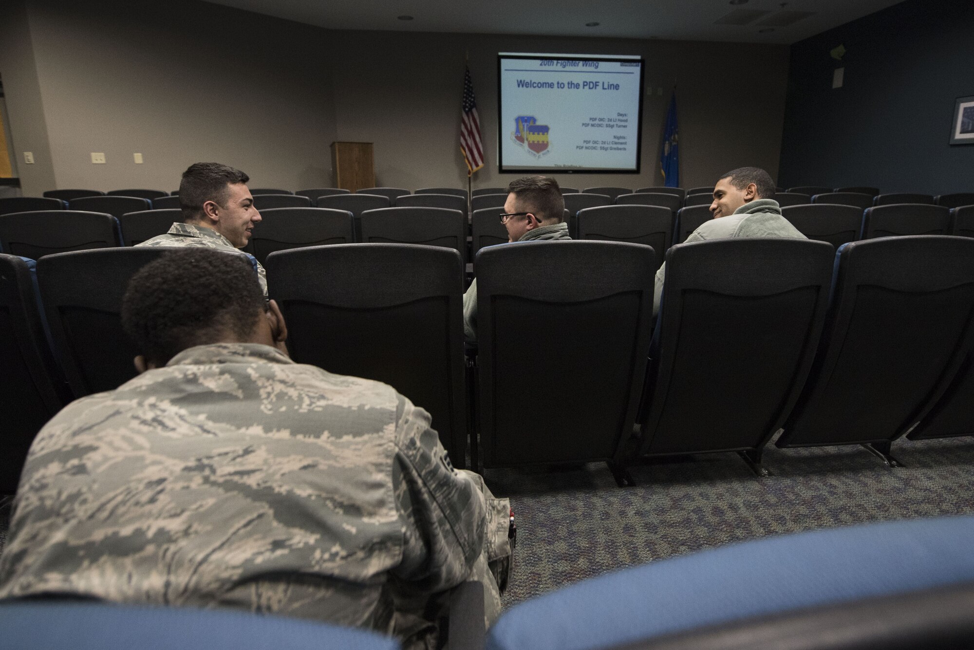 U.S. Airmen interact prior to receiving deployment briefs during a Phase I exercise at Shaw Air Force Base, S.C., Feb. 4, 2018.