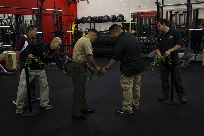 U.S. Marine Corps Col. Raul Lianez, commanding officer, Marine Corps Base Hawaii, along with Semper Fit staff reopen the base's Semper Fit High-Intensity Tactical Training (HITT) Center, Feb. 2, 2018. The newly remodeled HITT Center and Fitness Center feature new equipment, flooring, and infrastructure designed to ensure that Marines aboard the installation can produce readiness by being able to better ready themselves for the challenges of the modern warfighter. (U.S. Marine Corps photo by Sgt. Alex Kouns)