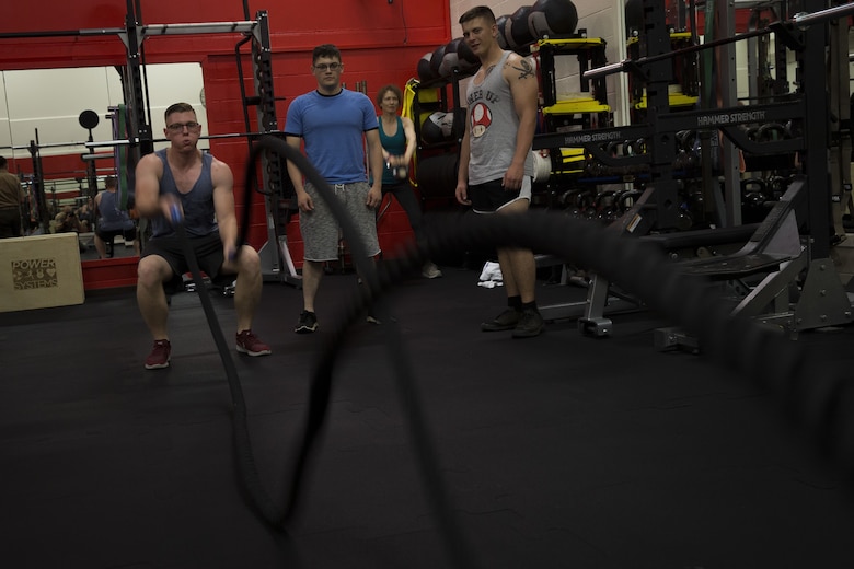 U.S. Marine Lance Cpl. Chase Clubb with 3rd Marine Radio Battalion, Marine Corps Base Hawaii, exercises using new rope equipment after the reopening of the base's Semper Fit High-Intensity Tactical Training (HITT) Center, Feb. 2, 2018. The newly remodeled HITT Center and Fitness Center feature new equipment, flooring, and infrastructure designed to ensure that Marines aboard the installation can produce readiness by being able to better ready themselves for the challenges of the modern warfighter. (U.S. Marine Corps photo by Sgt. Alex Kouns)