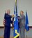 Maj. Gen. Bradley D. Spacy, commander of the Air Force Installation and Mission Support Center, passes the unit flag to Edwin H. Oshiba