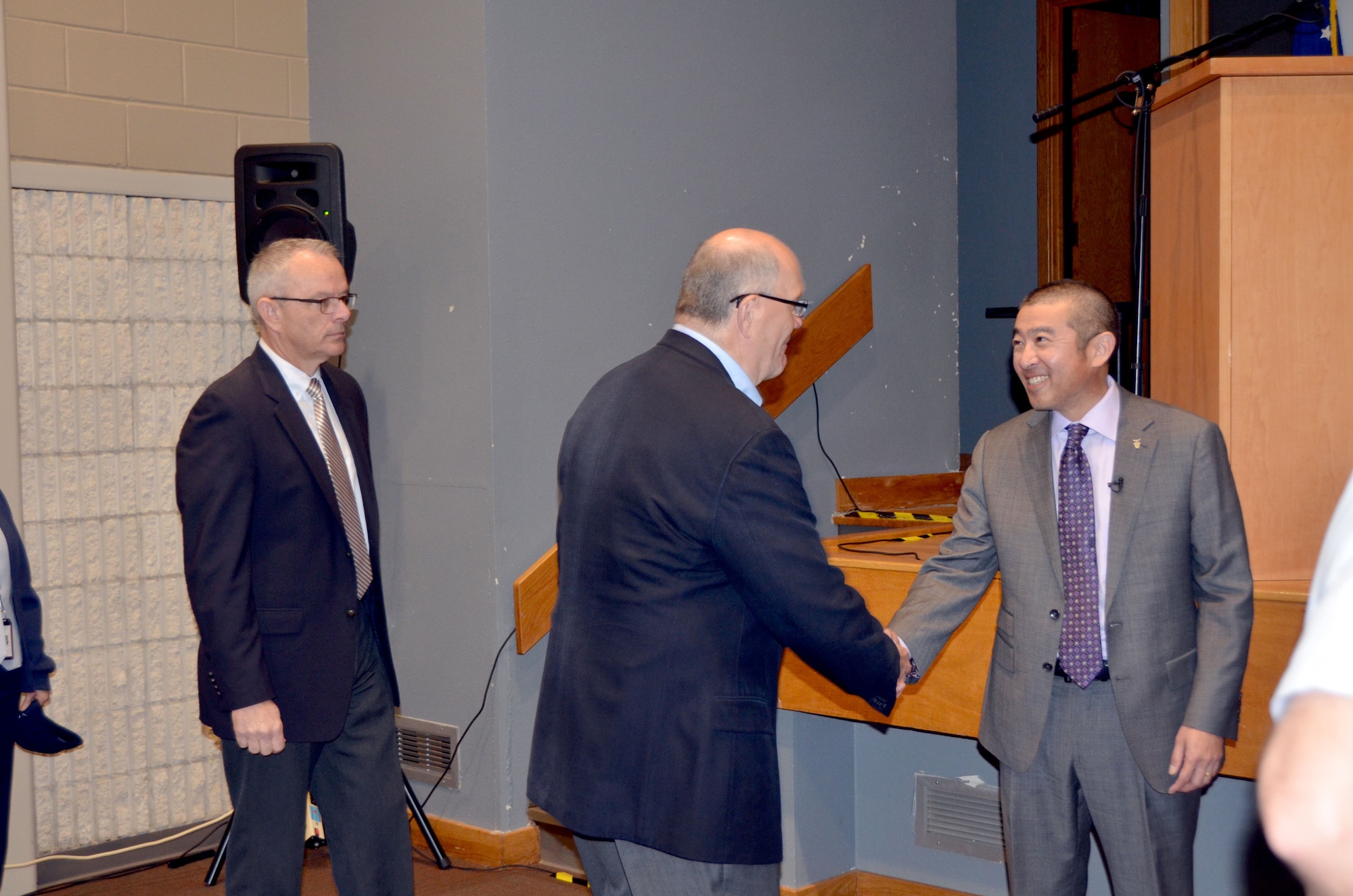 AFCEC’s new Director Ed Oshiba shakes hands with members of Team AFCEC and others gathered during his assumption of leadership ceremony