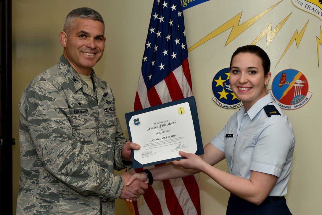 U.S. Air Force Col. Alex Ganster, 17th Training Group commander, presents the 315th Training Squadron Officer Student of the Month award for Jan. 2018 to 2nd Lt. Abigail Paxton, 315th TRS trainee, in the Brandenburg Hall on Goodfellow Air Force Base, Texas, Jan. 2, 2018. The 315th Training Squadron’s vision is to develop combat-ready intelligence, surveillance and reconnaissance professionals and promote an innovative squadron culture and identity unmatched across the United States Air Force.