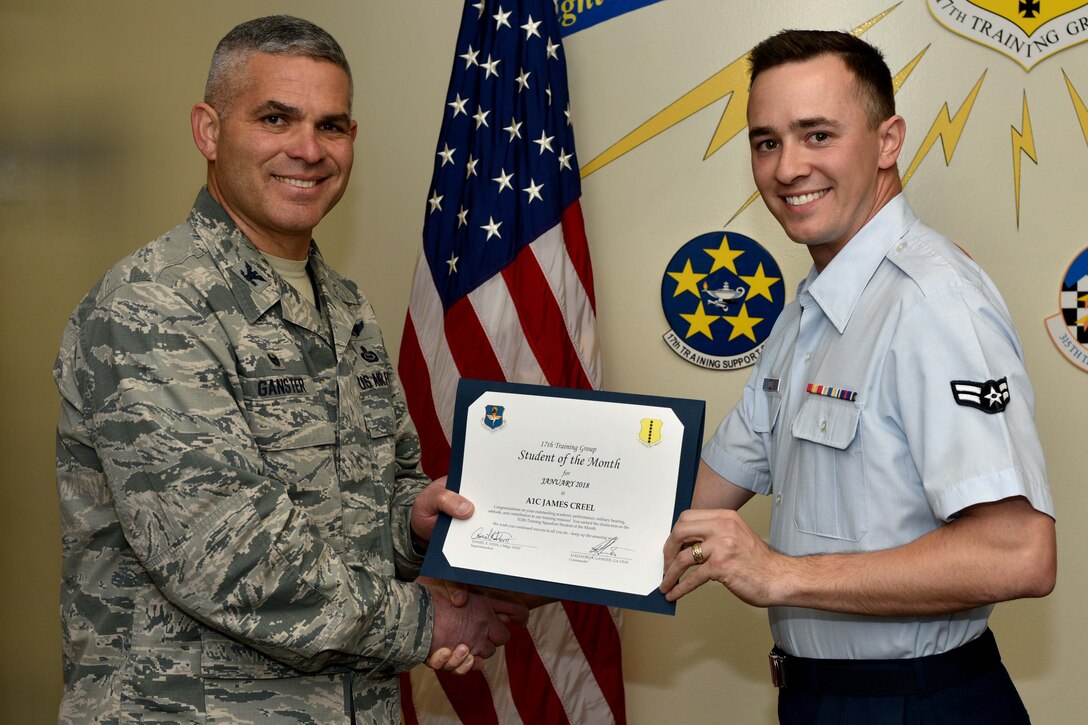 U.S. Air Force Col. Alex Ganster, 17th Training Group commander, presents the 312th Training Squadron Student of the Month award for Jan. 2018 to Airman 1st Class James Creel, 312th TRS trainee, in the Brandenburg Hall on Goodfellow Air Force Base, Texas, Jan. 2, 2018. The 312th TRS’s mission is to provide Department of Defense and international customers with mission ready fire protection and special instruments graduates and provide mission support for the Air Force Technical Applications Center.