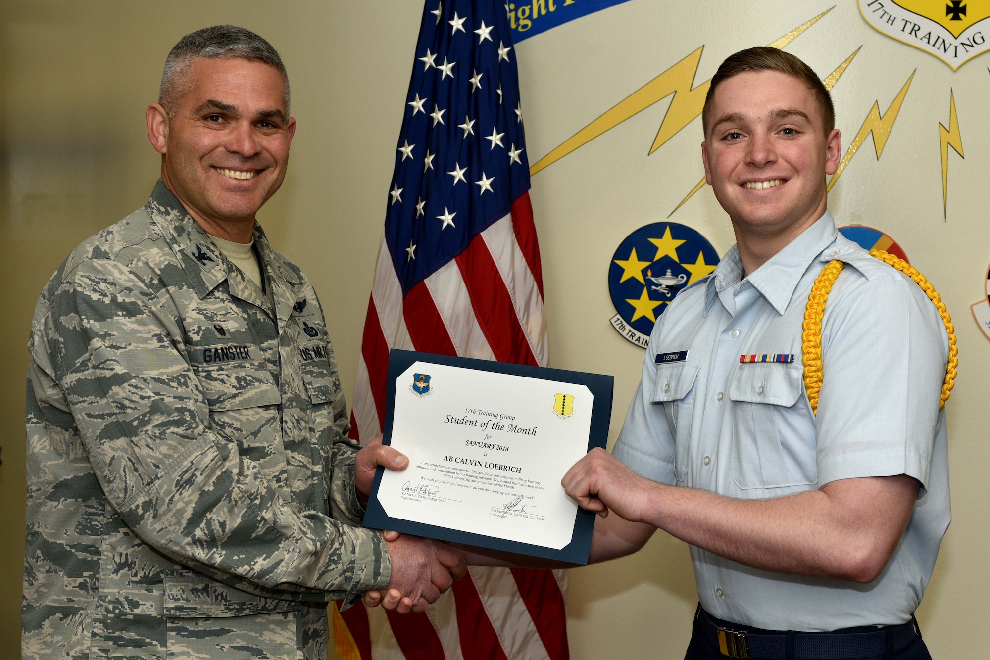 U.S. Air Force Col. Alex Ganster, 17th Training Group commander, presents the 315th Training Squadron Student of the Month award for Jan. 2018 to Airman Calvin Loebrich, 315th TRS trainee, in the Brandenburg Hall on Goodfellow Air Force Base, Texas, Jan. 2, 2018. The mission of the 17th Training Group is to Train, Develop and Inspire Professional Fire Protection and Intelligence, Surveillance and Reconnaissance Warriors.