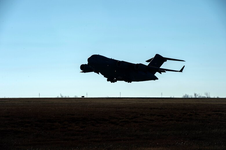 A C-17 Globemaster III takes off to perform aerial training