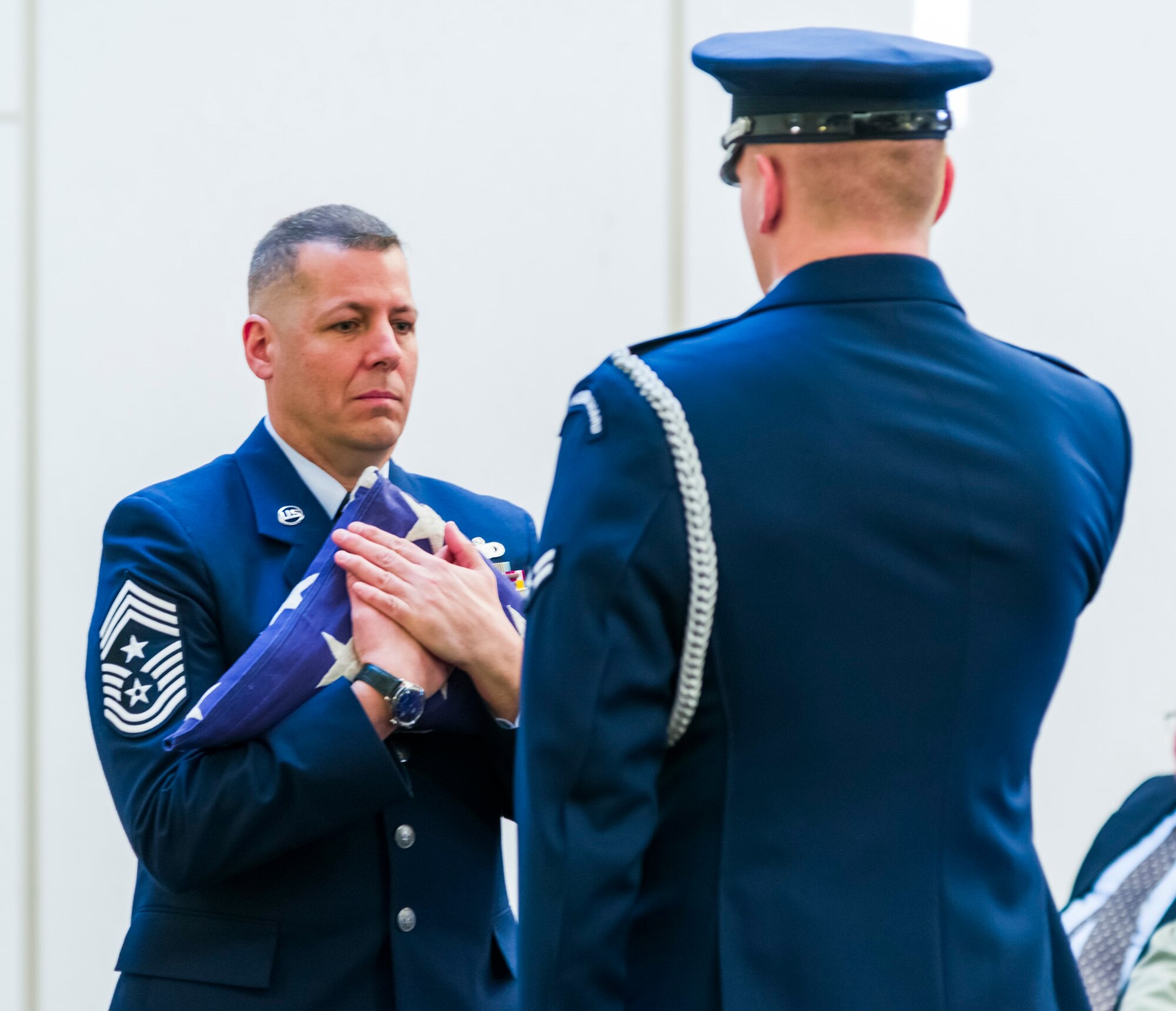 AFOSI Command Chief Master Sgt. #15 Christopher J. VanBurger, accepts the United States Flag from a member of the JBA Honor Guard during Chief VanBurger's retirement ceremony at Quantico, Va., Jan. 26, 2018. (U.S. Air Force photo by Michael Hastings)