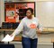 Tech Sgt. Andrea Porter, 9th Maintenance Group plans and scheduling section chief, passes out tests to students during the Yuba City Academic Decathlon