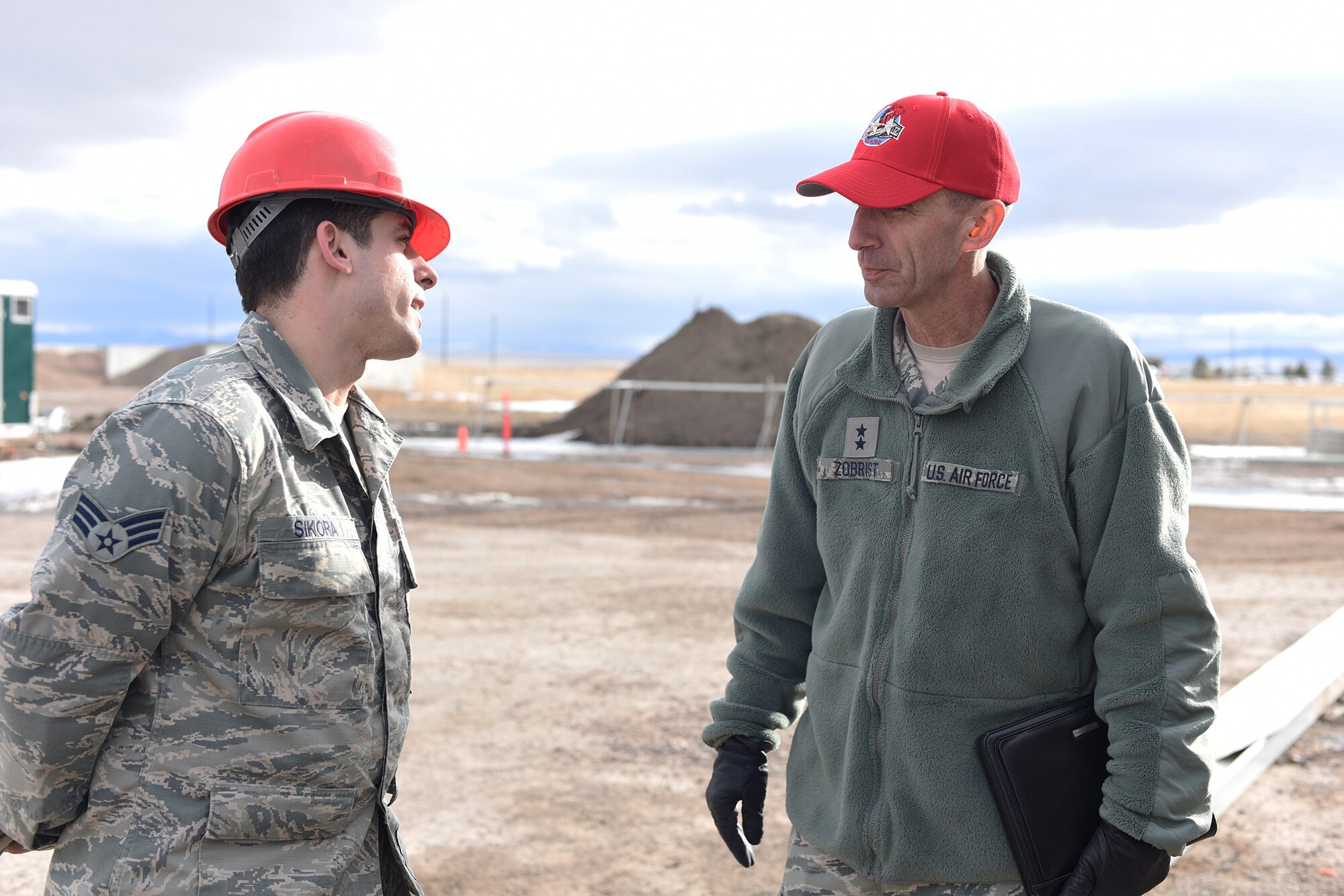 U.S. Air Force Maj. Gen. Scott J. Zobrist, right, 9th Air Force commander, speaks with Senior Airman Jonathon Sikora at the 819th Rapid Engineer Deployable Heavy Operational Repair Squadron Engineers (RED HORSE) K-Span troop training site at Malmstrom Air Force Base, Mont., Jan. 25, 2018. The K-Span storage facility is under construction and will be used to store RED HORSE assets. RED HORSE Airmen capitalize on construction opportunities while at home to maintain proficiency for their overseas missions.