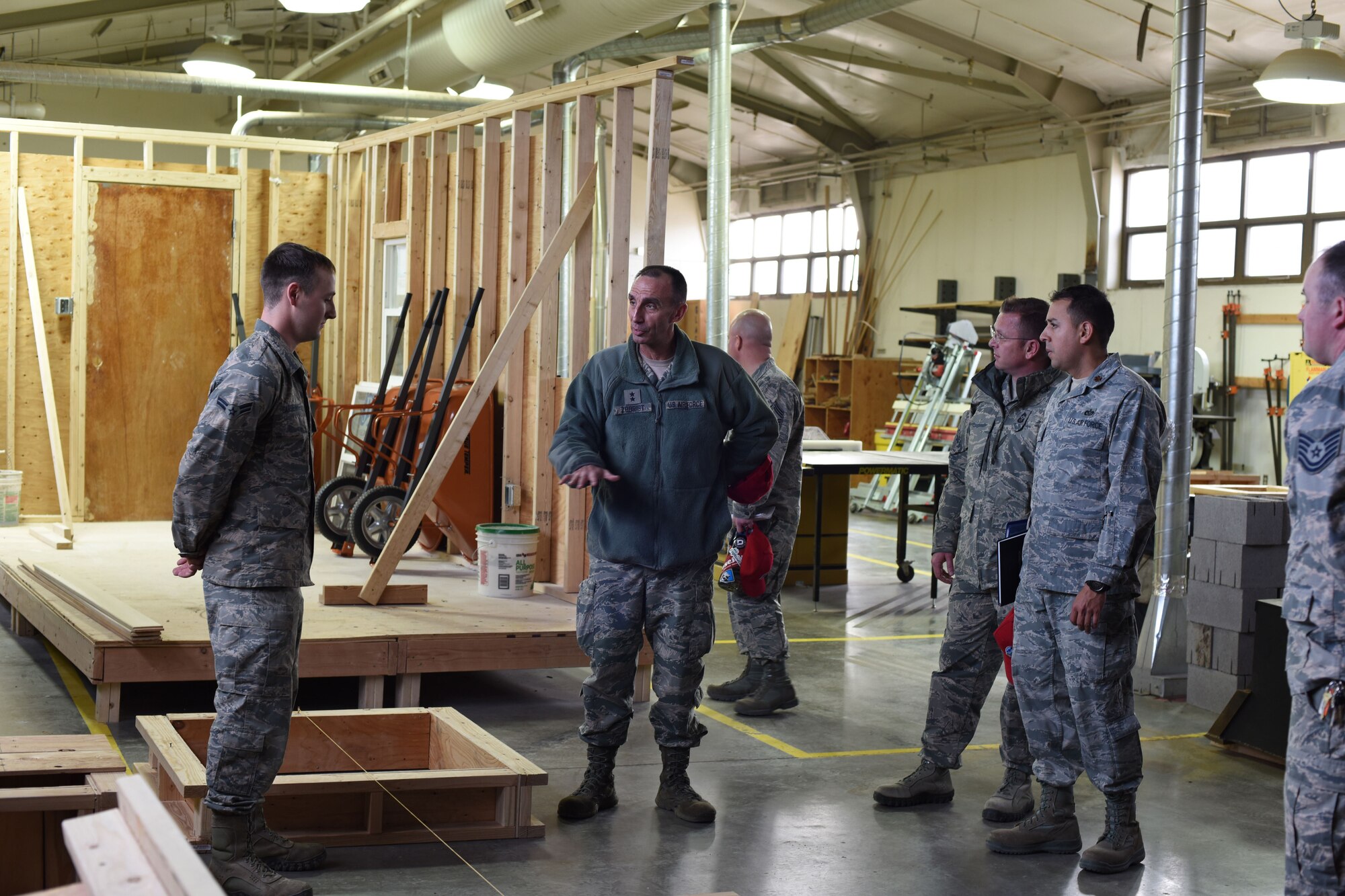 U.S. Air Force Maj. Gen. Scott J. Zobrist, center, 9th Air Force commander, speaks to Airman 1st Class Payton Gardenhire, 819th Rapid Engineer Deployable Heavy Operational Repair Squadron Engineers (RED HORSE) while touring the 819th RHS cantonments section at Malmstrom Air Force Base, Mont., Jan. 25, 2018. Along with Zobrist, 9th AF Command Chief Master Sgt. David W. Wade and Maj. Carlos Chirivi, 819th RHS commander, visited 819th RHS facilities and met with base leaders and Airmen for a mission update and to thank them for their support to 9th AF and worldwide operations, including upcoming deployments to U.S. Africa Command and U.S. Central Command. (U.S. Air Force photo by Kiersten McCutchan)