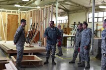 U.S. Air Force Maj. Gen. Scott J. Zobrist, center, 9th Air Force commander, speaks to Airman 1st Class Payton Gardenhire, 819th Rapid Engineer Deployable Heavy Operational Repair Squadron Engineers (RED HORSE) while touring the 819th RHS cantonments section at Malmstrom Air Force Base, Mont., Jan. 25, 2018. Along with Zobrist, 9th AF Command Chief Master Sgt. David W. Wade and Maj. Carlos Chirivi, 819th RHS commander, visited 819th RHS facilities and met with base leaders and Airmen for a mission update and to thank them for their support to 9th AF and worldwide operations, including upcoming deployments to U.S. Africa Command and U.S. Central Command. (U.S. Air Force photo by Kiersten McCutchan)
