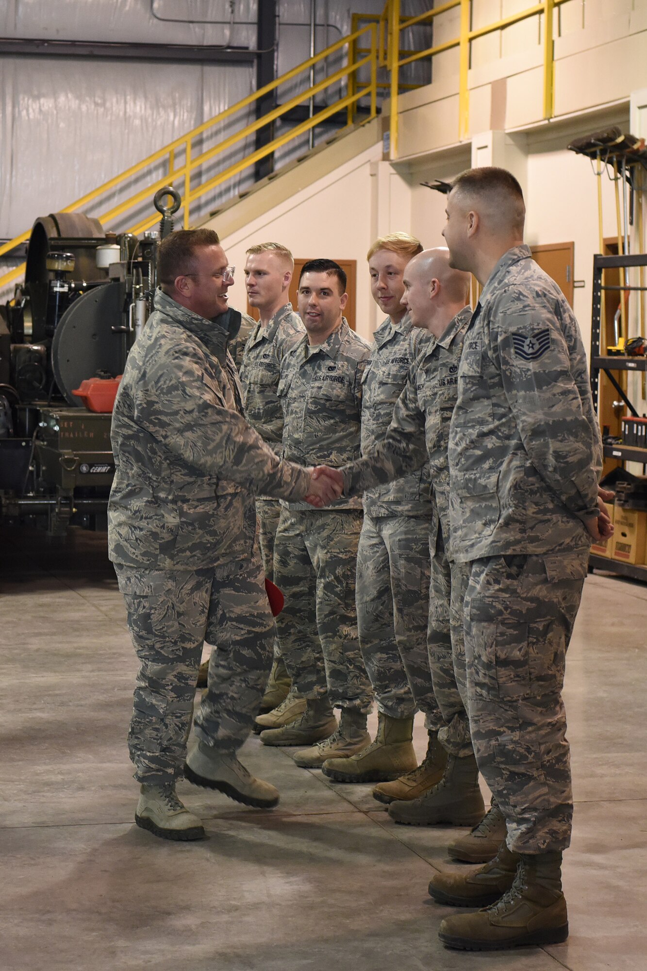 U.S. Air Force Chief Master Sgt. David W. Wade, 9th Air Force command chief, thanks members of the 819th Rapid Engineer Deployable Heavy Operational Repair Squadron Engineers (RED HORSE) power production section, at Malmstrom Air Force Base, Mont., Jan. 25, 2018. During his visit, Wade was briefed on the importance of the Mobile Aircraft Arresting System and the 819th RHS support to air shows around the country. (U.S. Air Force photo by Kiersten McCutchan)