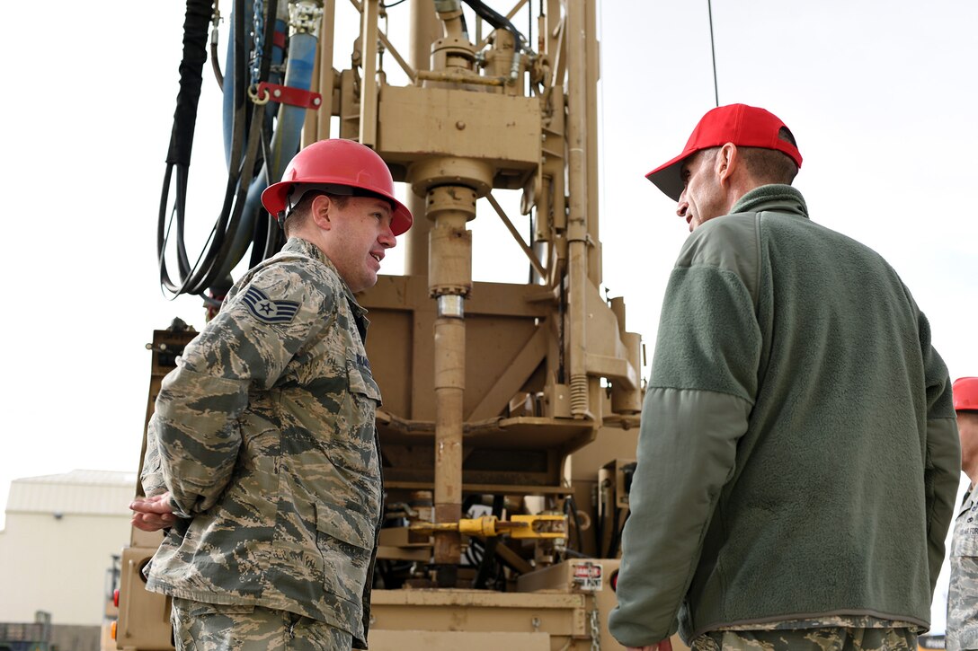 U.S. Air Force Staff Sgt. Jaymes Crumley, left, 819th Rapid Engineer Deployable Heavy Operational Repair Squadron Engineers (RED HORSE) noncommissioned officer in charge of the well drilling team, briefs Maj. Gen. Scott J. Zobrist, 9th Air Force commander, on the well drilling operations fielded by RED HORSE Airmen stationed at Malmstrom Air Force Base, Mont., Jan. 25, 2018. During the visit, the well drilling team discussed plans to employ their trade while supporting multiple U.S. Africa Command and U.S. Central Command objectives in both areas of responsibility this spring. (U.S. Air Force photo by Kiersten McCutchan)