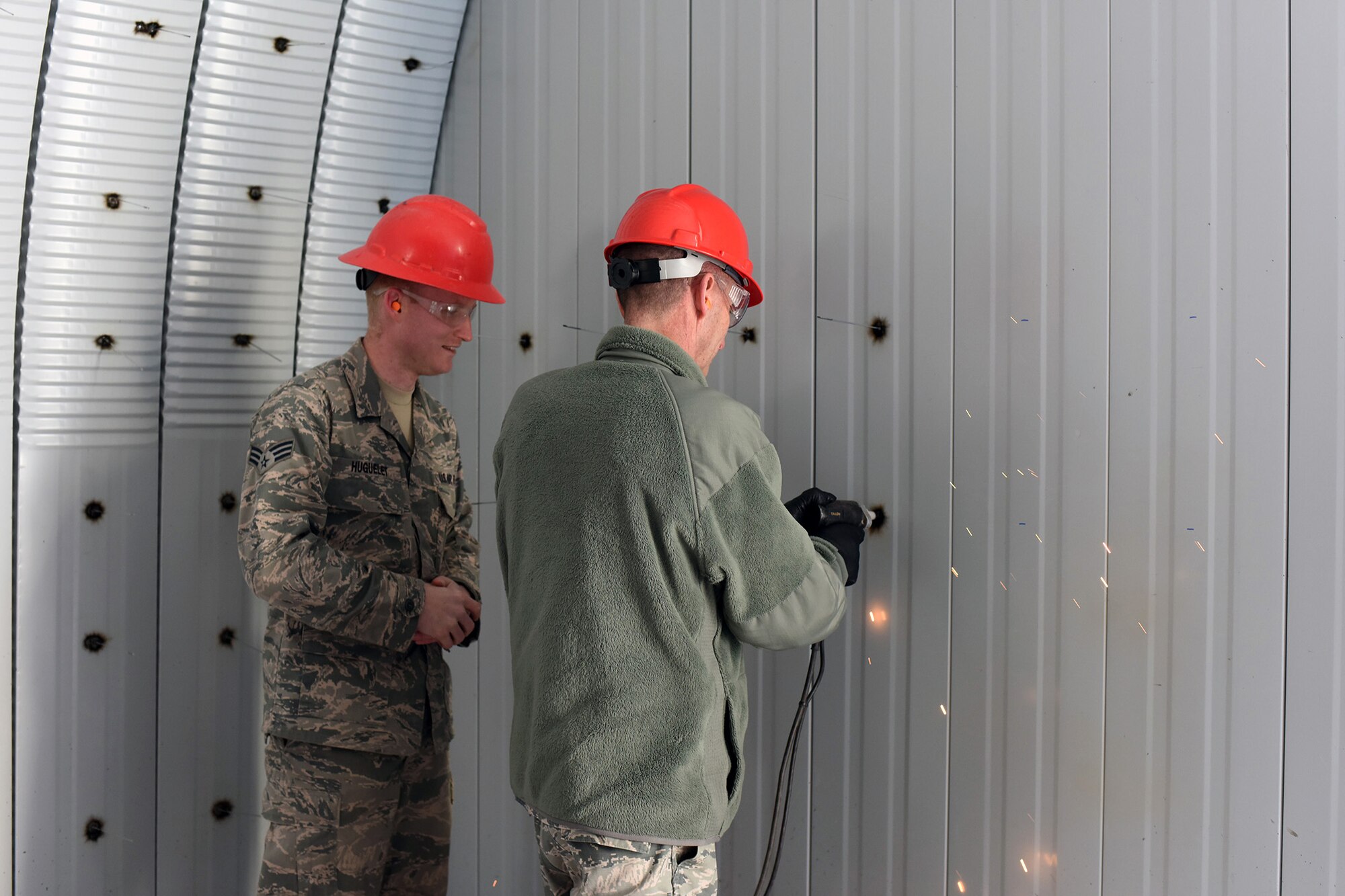 U.S. Air Force Maj. Gen. Scott J. Zobrist, right, 9th Air Force commander, welds a pin to support insulation for a K-Span storage facility at Malmstrom Air Force Base, Mont., while Senior Airman Seth Huguelet discusses welding techniques Jan. 25, 2018. Huguelet is among a team of 819th Rapid Engineer Deployable Heavy Operational Repair Squadron Engineers (RED HORSE) building a K-Space facility which will store RED HORSE equipment. RED HORSE Airmen capitalize on construction opportunities while at home to maintain proficiency for their overseas missions. (U.S. Air Force photo by Kiersten McCutchan)