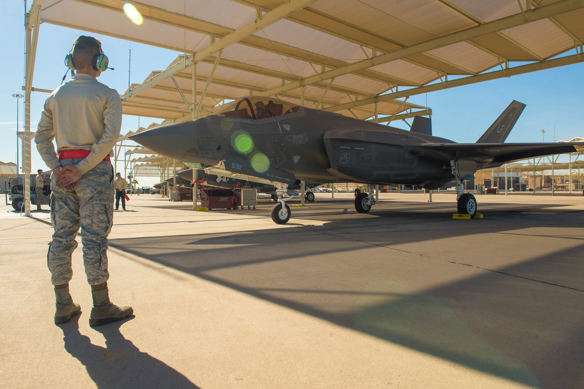 A crew chief assigned to the 63rd Aircraft Maintenance Unit prepares to marshal out an F-35A Lightning II for take-off at Luke Air Force Base, Ariz., Feb. 1, 2018. This year was the first time the F-35 participated in the Haboob Havoc, a fighter pilot competition, hosted by Thunderbolts. (U.S. Air Force photo/Airman 1st Class Caleb Worpel)