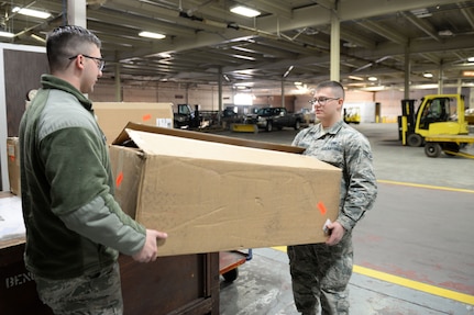 Airmen 1st Class Jacob Hickman and Colton Labrie, both 773d Logistics Readiness Squadron Documented Cargo vehicle operators, pick up cargo for a scheduled delivery Feb. 2, 2018, at Joint Base Elmendorf-Richardson. Documented Cargo establishes the most effective and efficient process to deliver cargo to the customer using scheduled delivery/pick-up sweeps throughout the installation.