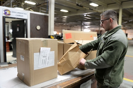 Airman 1st Class Jacob Hickman, a 773d Logistics Readiness Squadron Documented Cargo vehicle operator, checks the size of his next delivery Feb. 2, 2018, at Joint Base Elmendorf-Richardson. Documented Cargo establishes the most effective and efficient process to deliver cargo to the customer using scheduled delivery/pick-up sweeps throughout the installation.