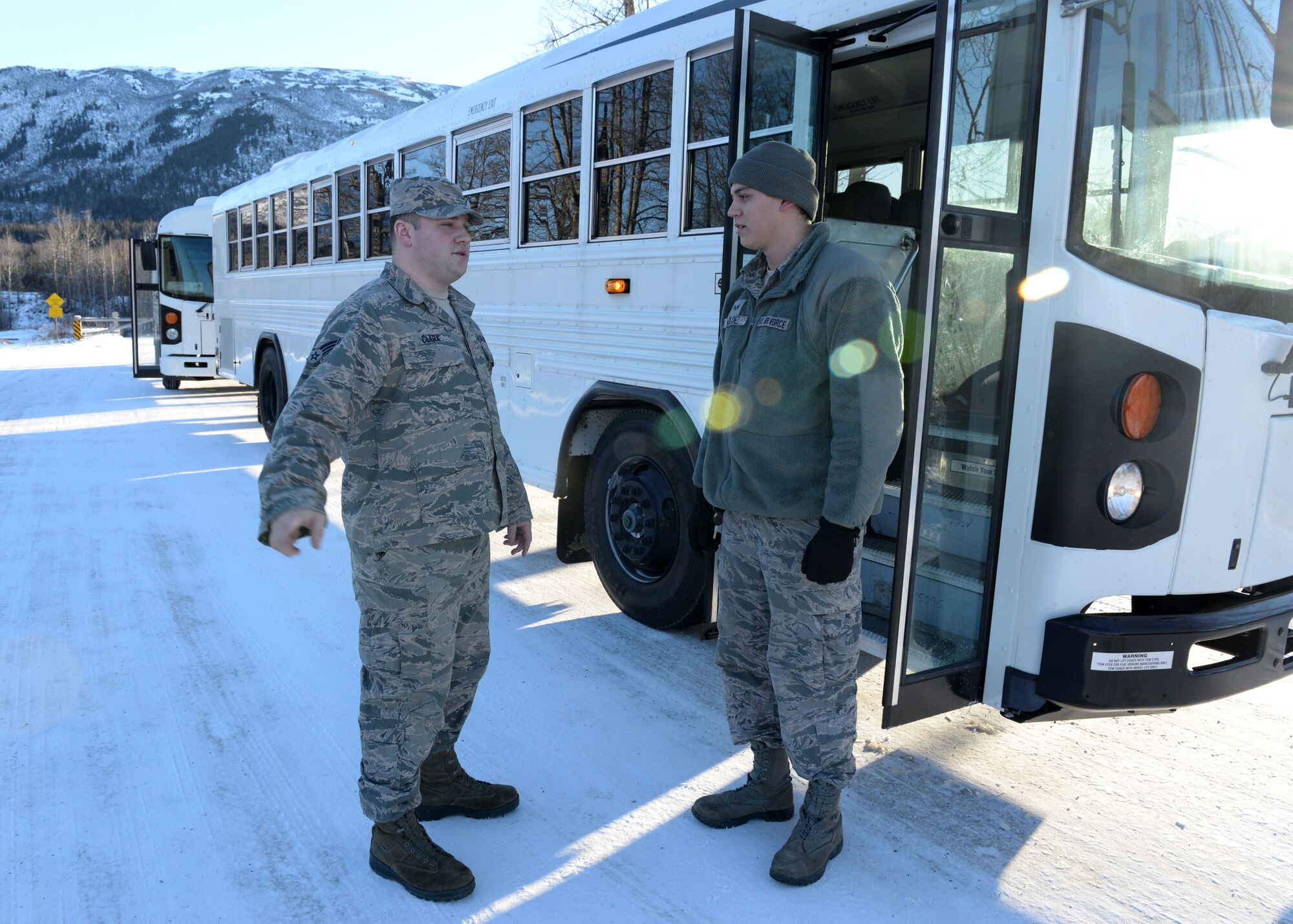 Senior Airmen Luke Clark and Joseph Valdez, vehicle operators and dispatchers with the 773d Logistics Readiness Squadron Vehicle Operation Control Center, discuss the logistics of a scheduled transport of troops, Feb. 2, 2018, at Joint Base Elmendorf-Richardson, Alaska. The VOCC ensures qualified vehicle operators are available to support all transportation requests.