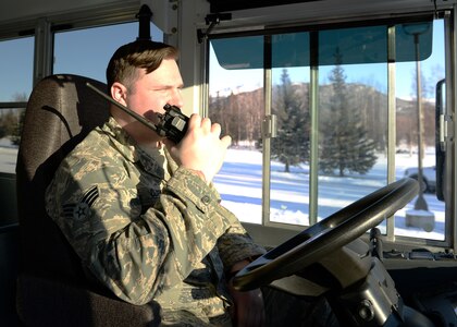 Senior Airman Luke Clark, a 773d Logistics Readiness Squadron Vehicle Operation Control Center vehicle operator and dispatcher, communicates with other drivers Feb. 2, 2018, at Joint Base Elmendorf-Richardson, Alaska. The VOCC ensures qualified vehicle operators are available to support all transportation requests.