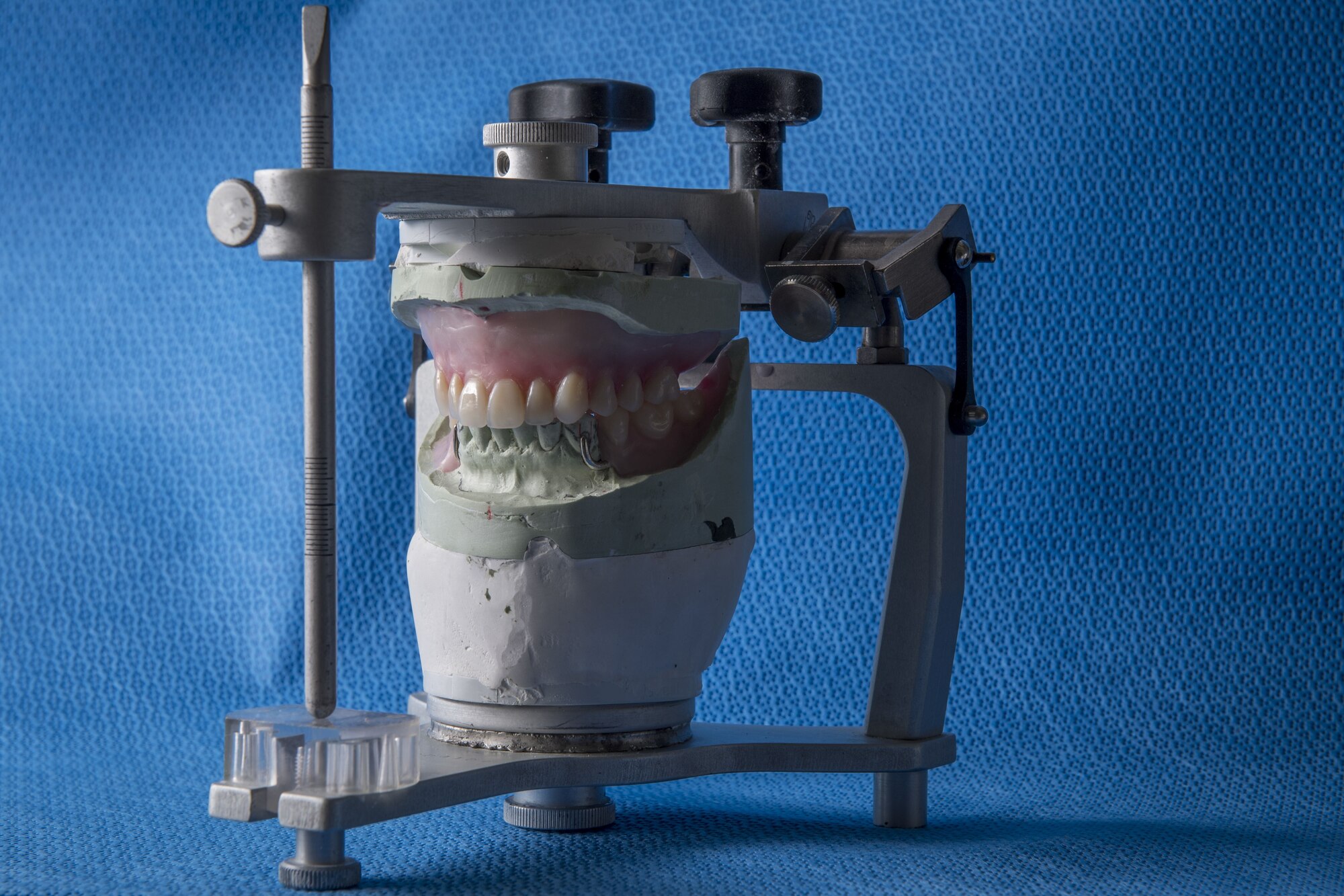 Uncompleted dentures sit in a vise to be worked on by the 374th Dental Squadron’s dental lab, Jan. 29, 2018, at Yokota Air Base, Japan.