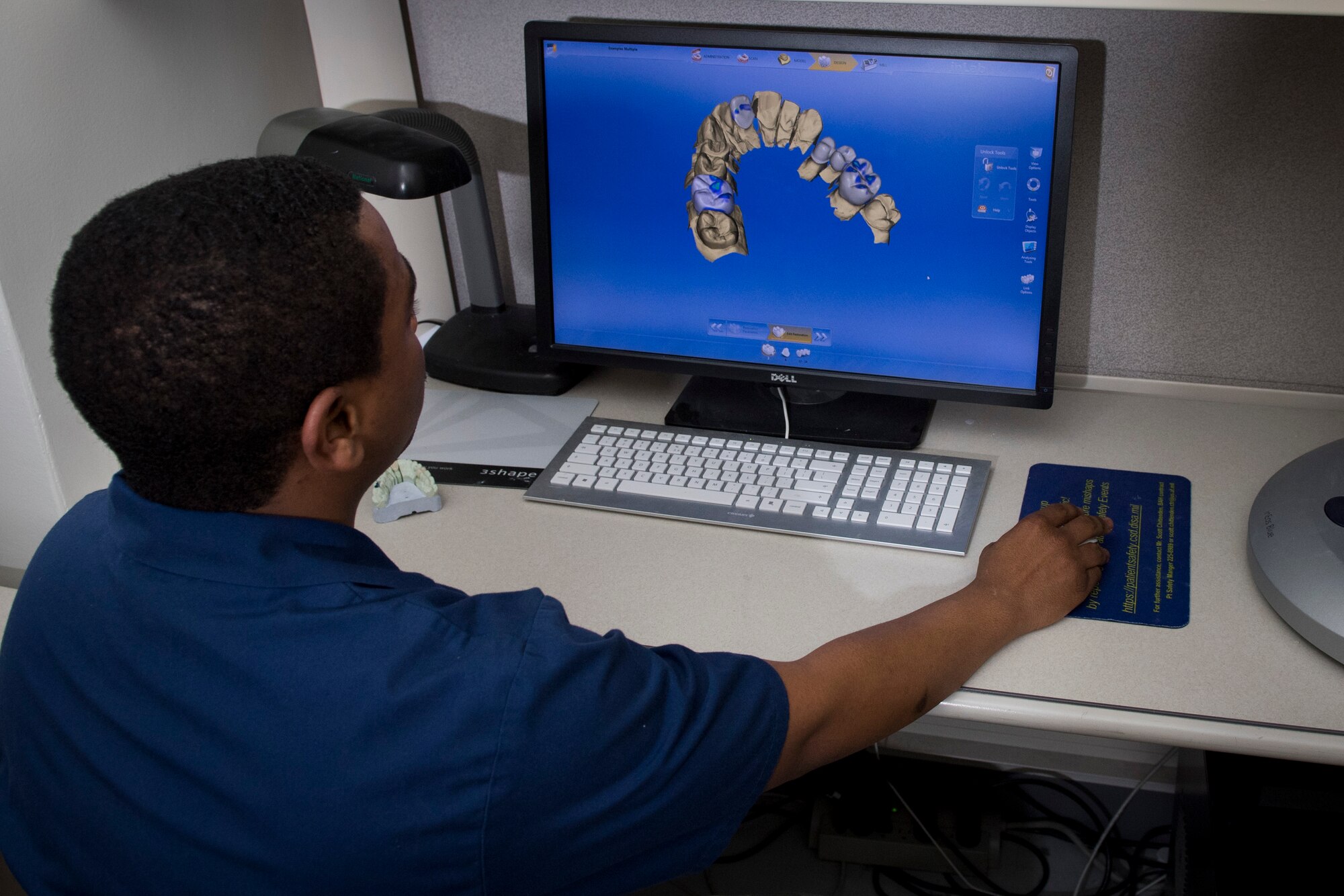Staff Sgt. Bryan Holloway, 374th Dental Squadron dental lab technician, digitally designs new teeth with computer added design software, Jan. 29, 2018, at Yokota Air Base, Japan.