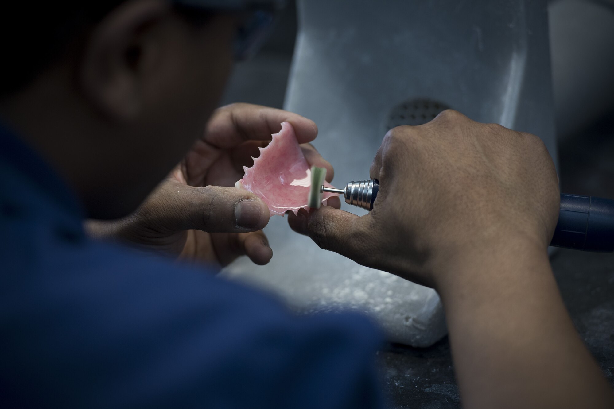 Staff Sgt. Bryan Holloway, 374th Dental Squadron dental lab technician, polishes a newly made prosthetic, Jan. 29, 2018, at Yokota Air Base, Japan.