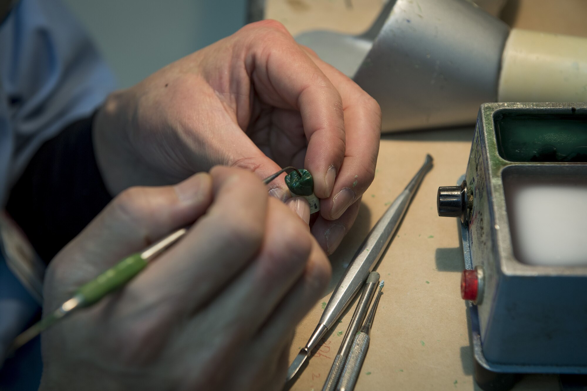 Nobuo Sakamoto, 374th Dental Squadron dental lab technician, molds a wax tooth by hand, Jan. 29, 2018, at Yokota Air Base, Japan.