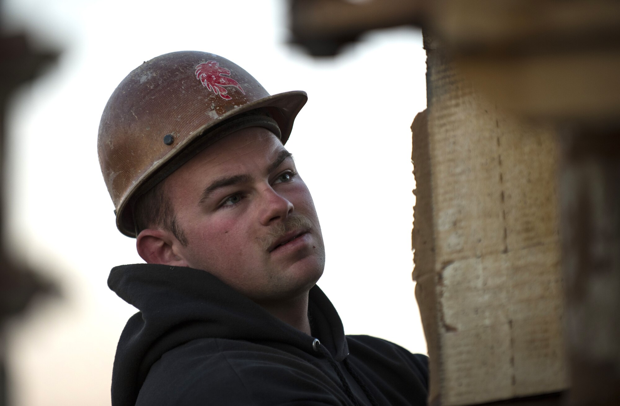 Senior Airman Rosco Ledbetter, a well driller assigned to the 557th Expeditionary RED HORSE Squadron, operates controls as the crew removes steel piping from a drill site January 31, 2018 at an undisclosed location in Southwest Asia. Well drillers are selected from various Air Force civil engineer specialties and frequently travel to remote areas to establish reliable flow of potable water. (U.S. Air Force photo by Staff Sgt. Joshua Kleinholz)