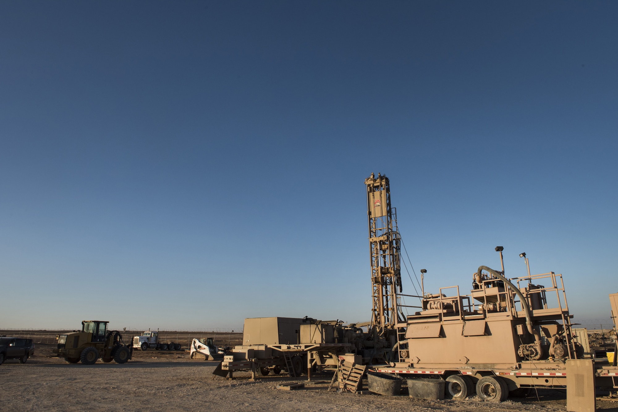 The sun sets on a 557th Expeditionary RED HORSE Squadron drill site January 31, 2018 at an undisclosed location in Southwest Asia. The project entails the development of 3 new wells intended to support an enduring coalition presence in the region. (U.S. Air Force photo by Staff Sgt. Joshua Kleinholz)